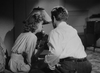 Movie still from “Detour” (1945), directed by Edgar G. Ulmer – A man and a woman sitting next to each other; Medium shot, High angle