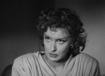 Movie still from “Detour” (1945), directed by Edgar G. Ulmer – A black - and - white photo of a woman looking at the camera; Close Up shot, Low angle