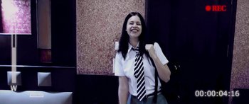 Movie still from “Dev.D” (2009), directed by Anurag Kashyap – A woman wearing a tie standing in front of a wall; Medium shot, Low angle