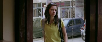 Movie still from “Dev.D” (2009), directed by Anurag Kashyap – A woman in a yellow shirt and a bag; Medium shot, Low angle