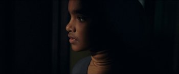 Movie still from “Dheepan” (2015), directed by Jacques Audiard – A person's face in the dark; Close Up shot, Over the shoulder angle