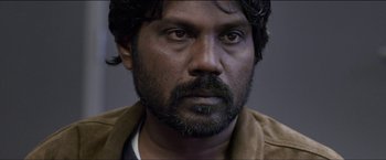 Movie still from “Dheepan” (2015), directed by Jacques Audiard – A person with a beard; Close Up shot, Over the shoulder angle