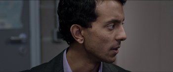 Movie still from “Dheepan” (2015), directed by Jacques Audiard – A person wearing a suit and tie; Close Up shot, Over the shoulder angle