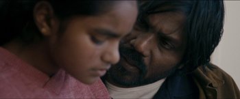 Movie still from “Dheepan” (2015), directed by Jacques Audiard – A person and a child face to face; Extreme Close Up shot, Over the shoulder angle
