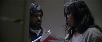 Movie still from “Dheepan” (2015), directed by Jacques Audiard – A man and a woman are looking at each other; Medium shot, Over the shoulder angle