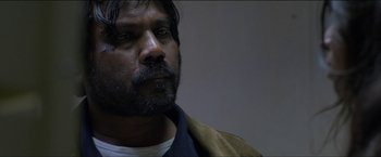 Movie still from “Dheepan” (2015), directed by Jacques Audiard – A person with a beard; Close Up shot, Over the shoulder angle