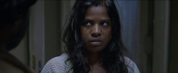 Movie still from “Dheepan” (2015), directed by Jacques Audiard – A person with long black hair; Close Up shot, Over the shoulder angle