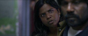 Movie still from “Dheepan” (2015), directed by Jacques Audiard – A person with long black hair; Close Up shot, Over the shoulder angle