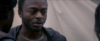 Movie still from “Dheepan” (2015), directed by Jacques Audiard – A person wearing a black jacket; Close Up shot, Over the shoulder angle