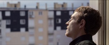 Movie still from “Dheepan” (2015), directed by Jacques Audiard – A person looking up at the sky; Close Up shot, Low angle