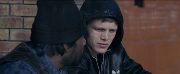 Movie still from “Dheepan” (2015), directed by Jacques Audiard – Two young men are talking to each other; Close Up shot, Over the shoulder angle