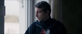 Movie still from “Dheepan” (2015), directed by Jacques Audiard – A person looking out of a window; Close Up shot, Low angle