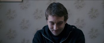 Movie still from “Dheepan” (2015), directed by Jacques Audiard – A person wearing a black jacket; Close Up shot, High angle