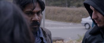 Movie still from “Dheepan” (2015), directed by Jacques Audiard – A person with a beard; Close Up shot, Over the shoulder angle