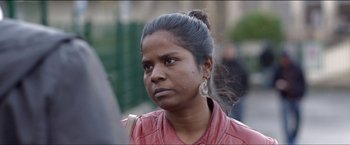 Movie still from “Dheepan” (2015), directed by Jacques Audiard – A person wearing a pink jacket; Close Up shot, Over the shoulder angle