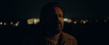Movie still from “Dheepan” (2015), directed by Jacques Audiard – A person wearing a brown shirt; Close Up shot, Low angle