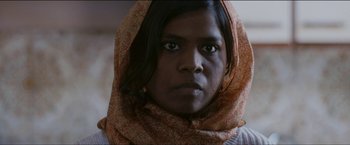 Movie still from “Dheepan” (2015), directed by Jacques Audiard – A woman with a scarf around her head; Close Up shot, Low angle