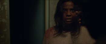 Movie still from “Dheepan” (2015), directed by Jacques Audiard – A person with long hair and a sweater on; Close Up shot, Over the shoulder angle