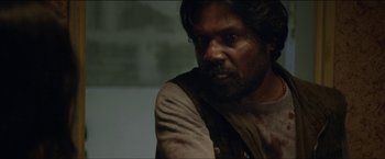 Movie still from “Dheepan” (2015), directed by Jacques Audiard – A person wearing a shirt; Close Up shot, Over the shoulder angle