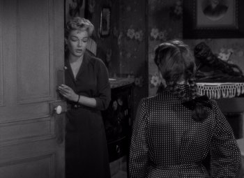 Movie still from “Diabolique” (1955), directed by Henri-Georges Clouzot – Two women are standing in front of each other; Medium shot, High angle