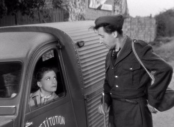 Movie still from “Diabolique” (1955), directed by Henri-Georges Clouzot – An old photo of a man and a boy in a truck; Medium shot, Over the shoulder angle