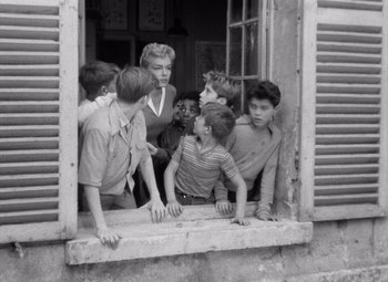 Movie still from “Diabolique” (1955), directed by Henri-Georges Clouzot – A group of children looking out of a window; Medium shot, High angle