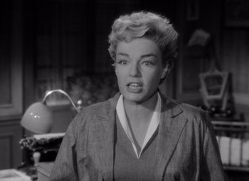 Movie still from “Diabolique” (1955), directed by Henri-Georges Clouzot – A black - and - white photo of a woman in a kitchen; Close Up shot, Low angle