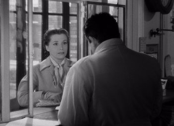 Movie still from “Diabolique” (1955), directed by Henri-Georges Clouzot – A man and a woman sitting in front of each other; Medium shot, Over the shoulder angle