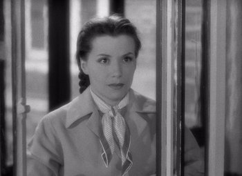 Movie still from “Diabolique” (1955), directed by Henri-Georges Clouzot – A black - and - white photo of a woman looking out of a window; Close Up shot, High angle