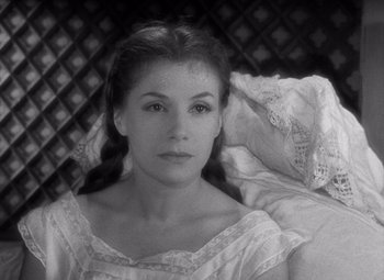 Movie still from “Diabolique” (1955), directed by Henri-Georges Clouzot – A black - and - white photo of a young woman; Close Up shot, High angle