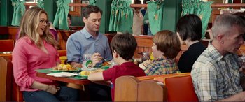 Movie still from “Diary of a Wimpy Kid: The Long Haul” (2017), directed by David Bowers – A man sitting at a table with two boys; Medium shot, Over the shoulder angle