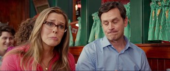 Movie still from “Diary of a Wimpy Kid: The Long Haul” (2017), directed by David Bowers – A man and a woman sitting next to each other at a table; Close Up shot, Over the shoulder angle