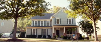 Movie still from “Diary of a Wimpy Kid: The Long Haul” (2017), directed by David Bowers – A house with a porch sitting in front of a tree; Extreme Wide shot, High angle