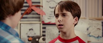 Movie still from “Diary of a Wimpy Kid: The Long Haul” (2017), directed by David Bowers – A young boy is looking into the distance; Close Up shot, Over the shoulder angle
