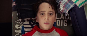 Movie still from “Diary of a Wimpy Kid: The Long Haul” (2017), directed by David Bowers – A young boy with a red shirt on; Close Up shot, Overhead angle