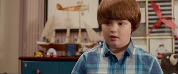 Movie still from “Diary of a Wimpy Kid: The Long Haul” (2017), directed by David Bowers – A young boy in a blue plaid shirt; Close Up shot, Over the shoulder angle
