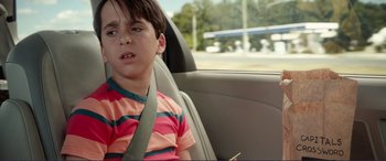 Movie still from “Diary of a Wimpy Kid: The Long Haul” (2017), directed by David Bowers – A young boy sitting in the back seat of a car; Close Up shot, Over the shoulder angle