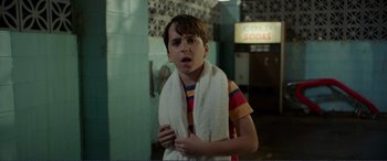 Movie still from “Diary of a Wimpy Kid: The Long Haul” (2017), directed by David Bowers – A young boy wrapped in a towel in a bathroom; Close Up shot, Over the shoulder angle