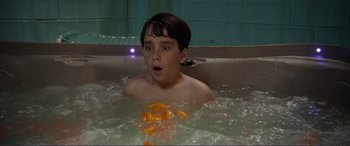 Movie still from “Diary of a Wimpy Kid: The Long Haul” (2017), directed by David Bowers – A young boy in a hot tub surrounded by orange slices; Close Up shot, High angle