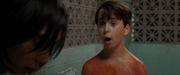 Movie still from “Diary of a Wimpy Kid: The Long Haul” (2017), directed by David Bowers – A young boy looking into a mirror with a surprised look on his face; Close Up shot, High angle