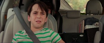Movie still from “Diary of a Wimpy Kid: The Long Haul” (2017), directed by David Bowers – A boy sitting in the back seat of a car; Close Up shot, Over the shoulder angle