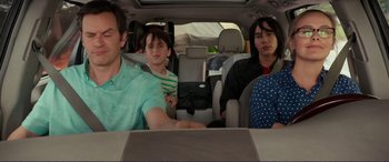 Movie still from “Diary of a Wimpy Kid: The Long Haul” (2017), directed by David Bowers – A group of people sitting in the back of a car; Medium shot, Over the shoulder angle