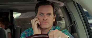 Movie still from “Diary of a Wimpy Kid: The Long Haul” (2017), directed by David Bowers – A man in plaid shirt talking on a cell phone; Close Up shot, High angle