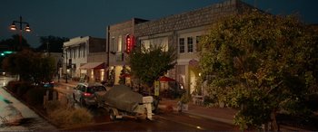 Movie still from “Diary of a Wimpy Kid: The Long Haul” (2017), directed by David Bowers – A street scene with a boat parked on the side of the road; Extreme Wide shot, High angle