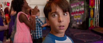 Movie still from “Diary of a Wimpy Kid: The Long Haul” (2017), directed by David Bowers – A young boy looking at the camera with an intense look on his face; Close Up shot, Over the shoulder angle