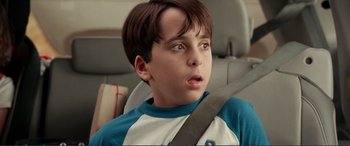 Movie still from “Diary of a Wimpy Kid: The Long Haul” (2017), directed by David Bowers – A boy sitting in the back seat of a car; Close Up shot, Over the shoulder angle