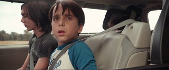 Movie still from “Diary of a Wimpy Kid: The Long Haul” (2017), directed by David Bowers – A boy sitting in the back seat of a car; Close Up shot, Over the shoulder angle
