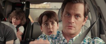 Movie still from “Diary of a Wimpy Kid: The Long Haul” (2017), directed by David Bowers – A man and a boy sitting in the back seat of a car; Close Up shot, Over the shoulder angle