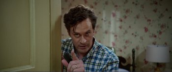 Movie still from “Diary of a Wimpy Kid: The Long Haul” (2017), directed by David Bowers – A person holding a cell phone; Close Up shot, Over the shoulder angle