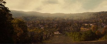 Movie still from “Diary of a Wimpy Kid: The Long Haul” (2017), directed by David Bowers – An aerial view of a small town in the mountains; Extreme Wide shot, High angle